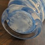 Ground polished pontil mark on base of hand-blown blue and white swirl art glass vase