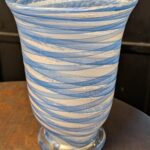 Hand-blown blue and white swirl art glass vase with footed trumpet form, front view