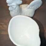 Interior view of vintage white porcelain rooster covered candy dish showing clean glazed bowl basin with rooster body in background